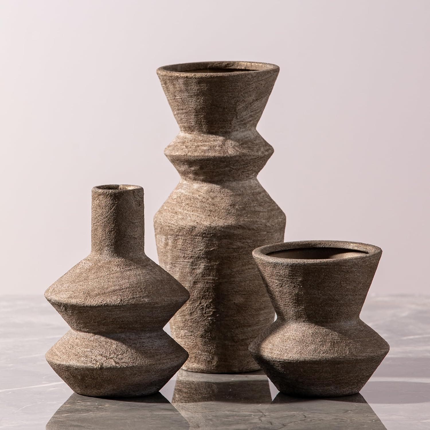 Set of three brown ceramic vases in graduated heights