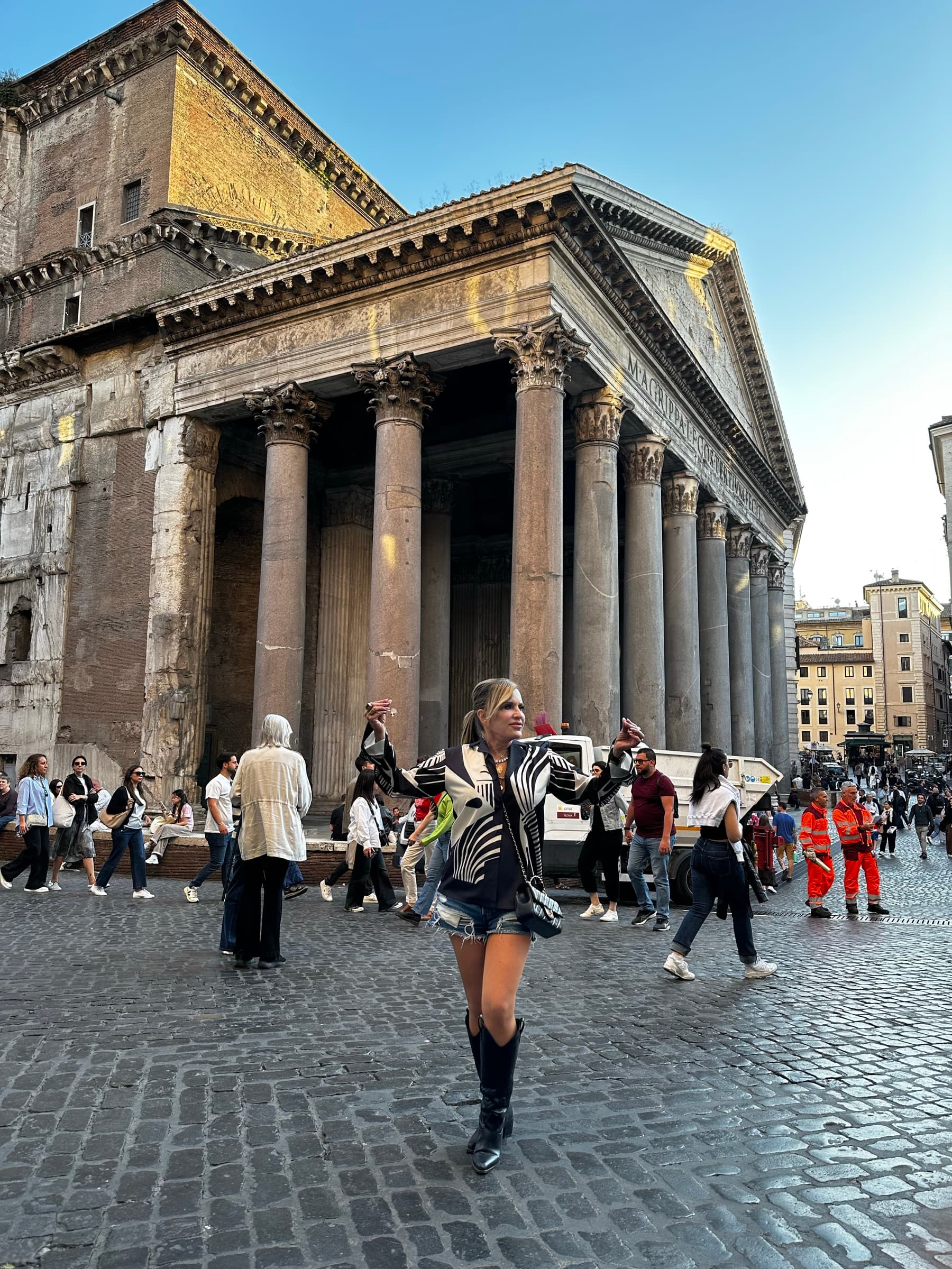 Giselle Koy standing before the columned portico of the Pantheon in Rome.