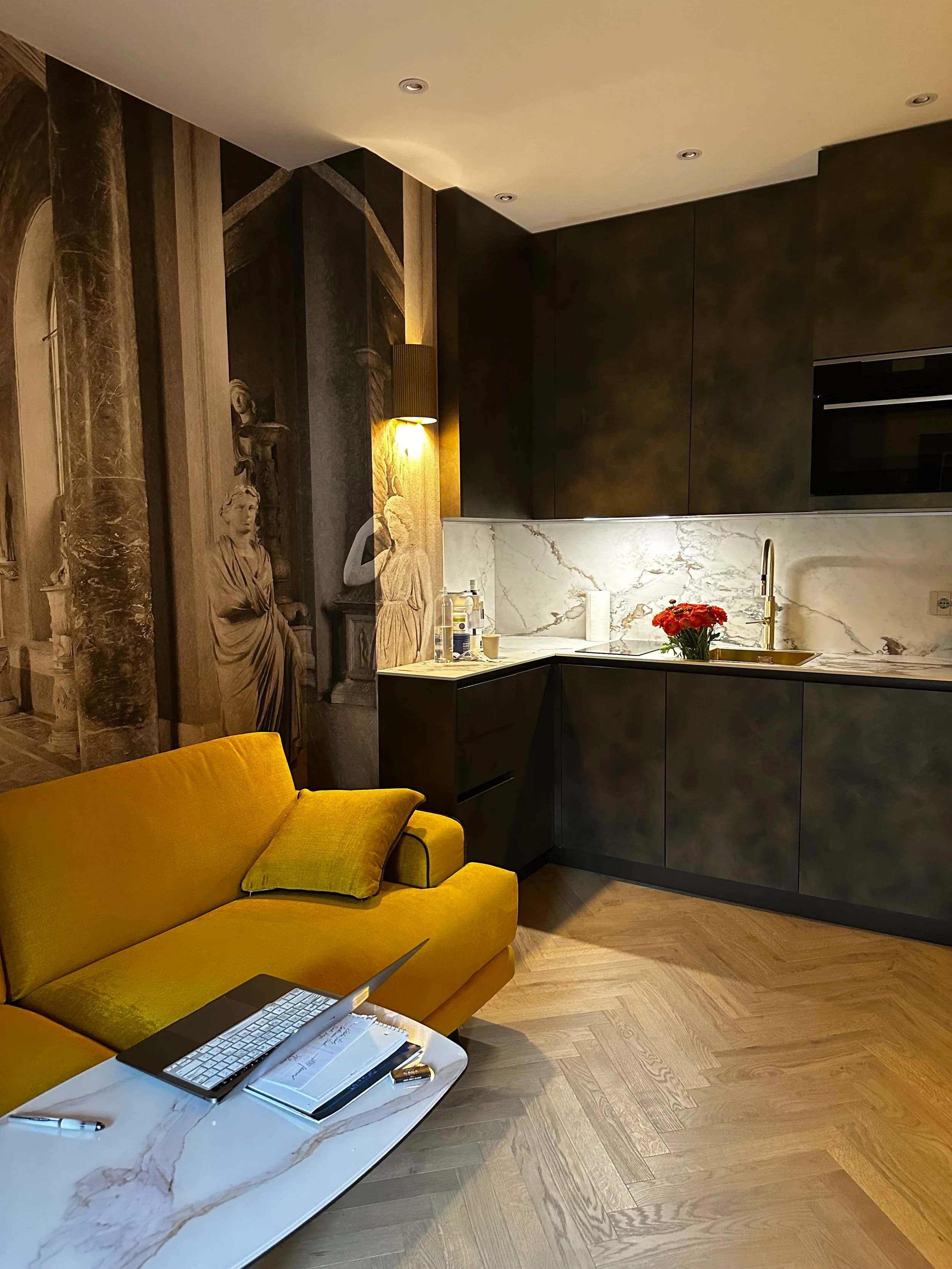 Milan Jewel kitchen — marble backsplash, canary velvet banquette, warm brass hardware
