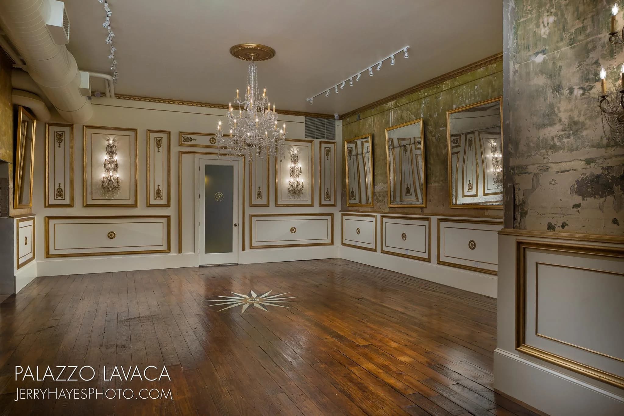 Grand chandelier in a gilded ballroom — the defining gesture of the Hollywood Regency language
